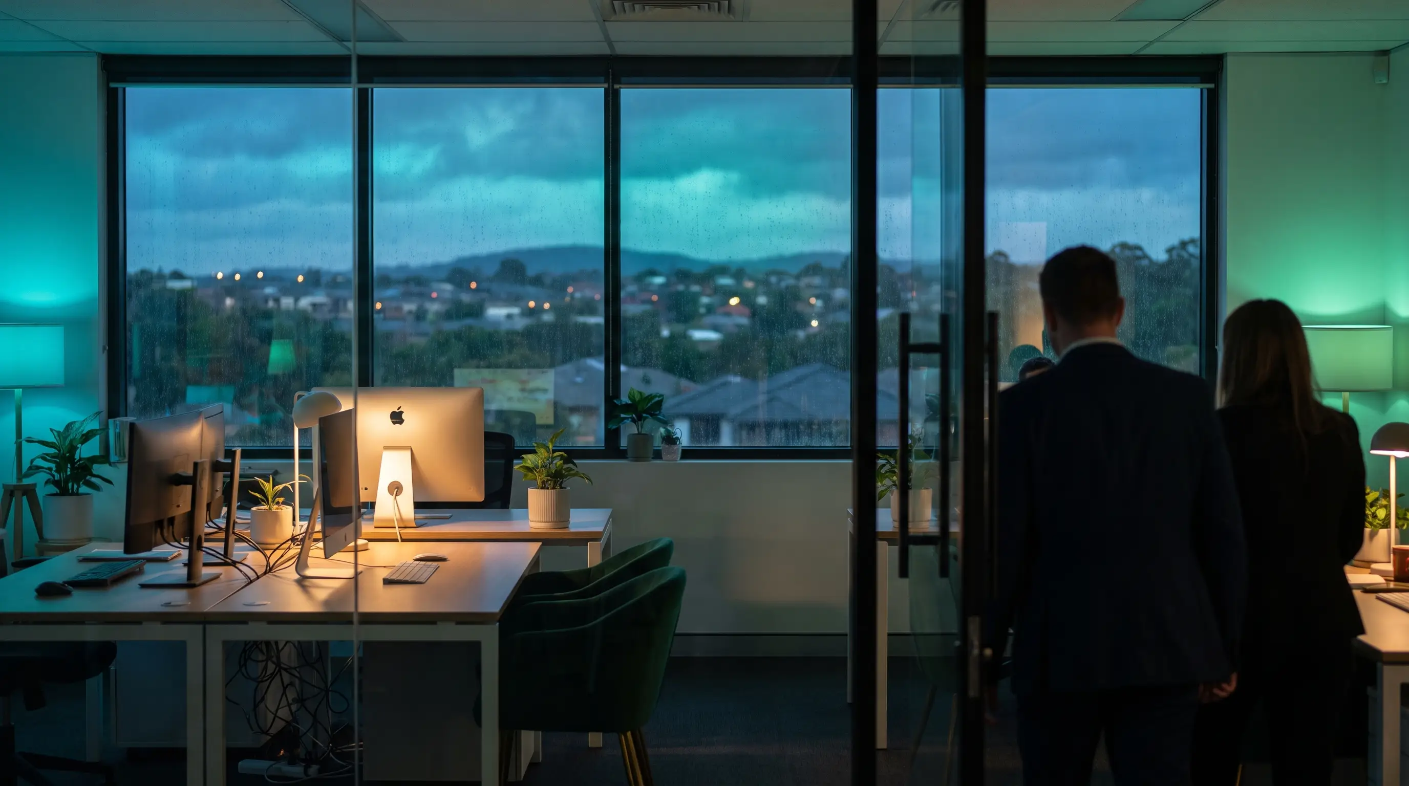A technician working alongside an in-house IT team in a modern office, resolving a deskside issue